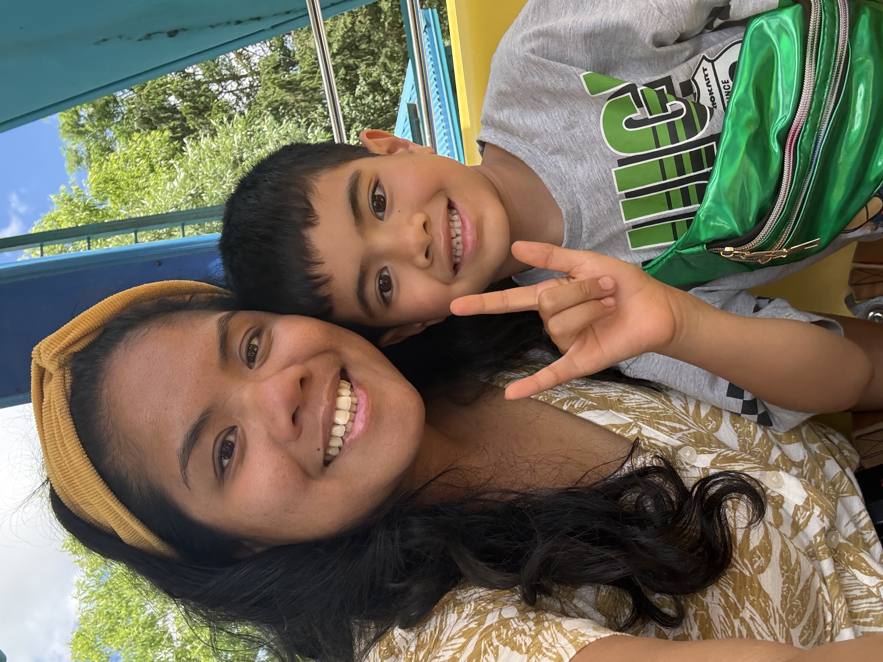 Kris Daria and her son Jayden, who is signing I-love-you in ASL